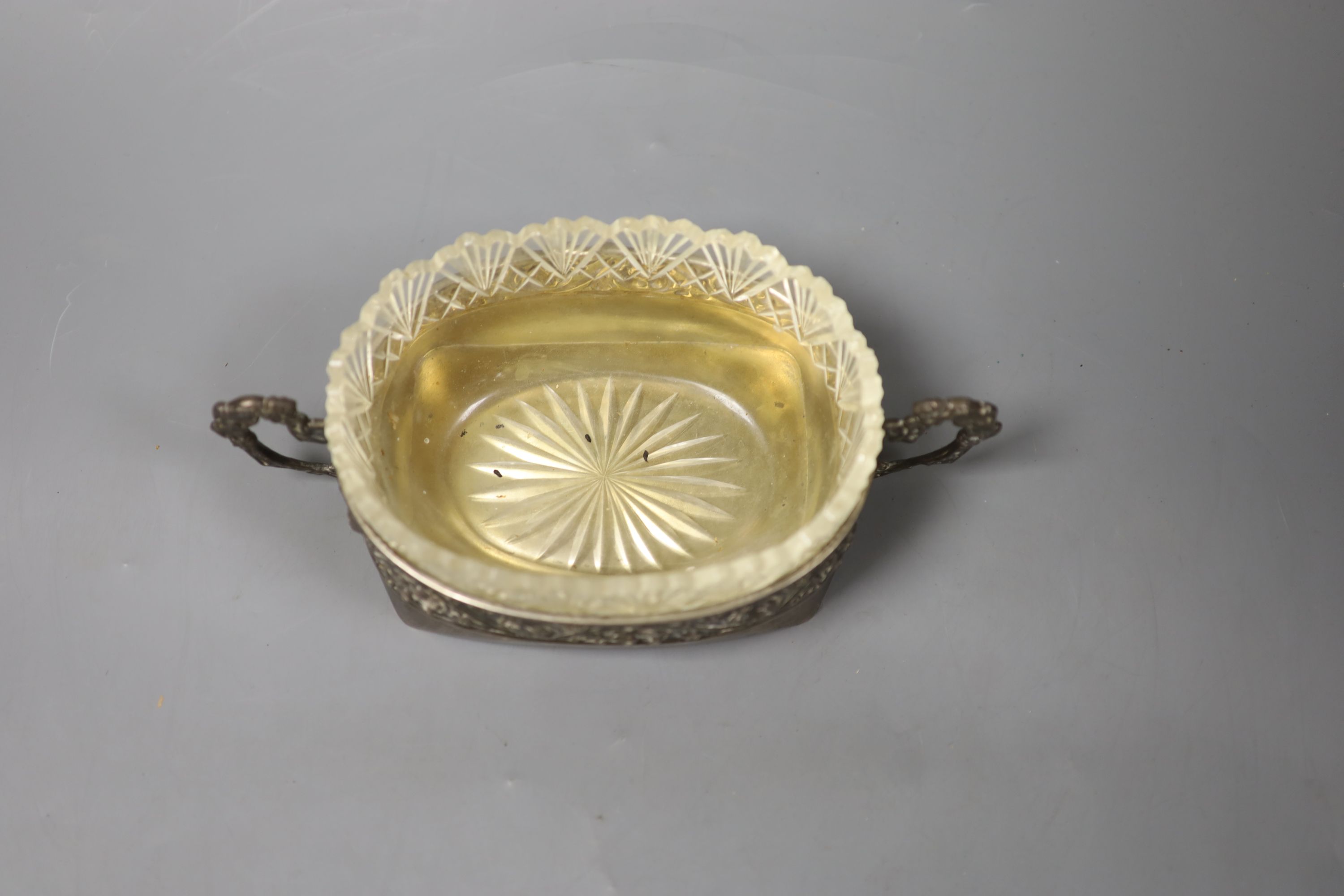 An early 20th century Russian white metal two handled oval dish with glass liner